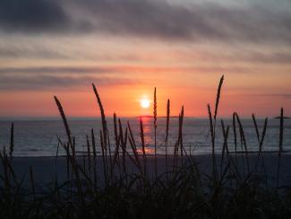 Midnight sunset on the beach. Atlantic ocean, Norway