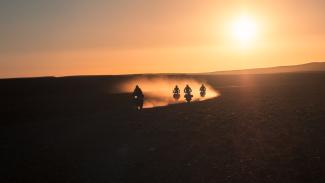 Riders on motorbike through the Moroccan desert