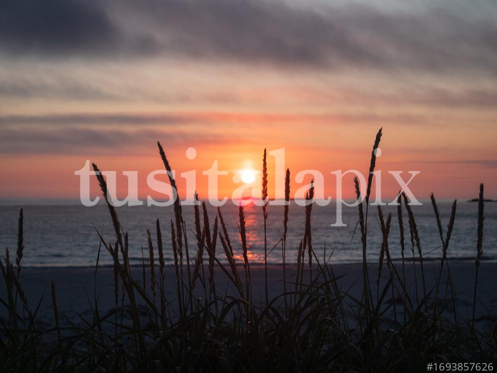 Midnight sunset on the beach. Atlantic ocean, Norway