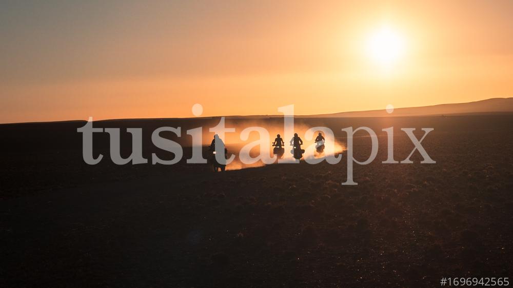 Riders on motorbike through the Moroccan desert